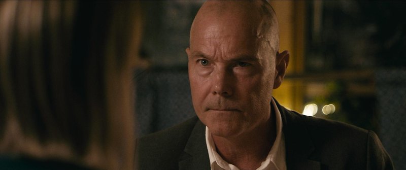 Bild från filmen #Gärdet. Närbild på en man med sammanbiten blick.